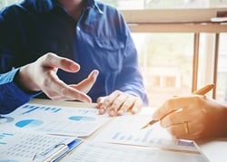 Two people reviewing financials