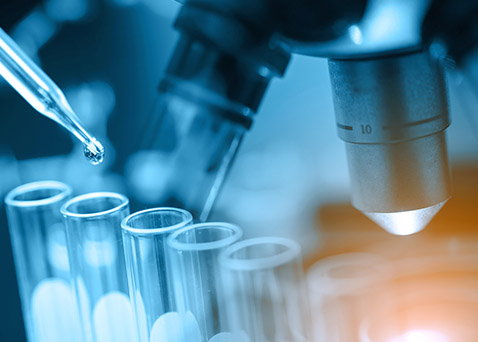 Photo of a pipette dangling above a vial